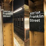 Two of the "Aretha" Franklin Street signs, located on the northbound side of the station